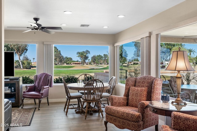 sunroom with a ceiling fan, visible vents, and a wealth of natural light