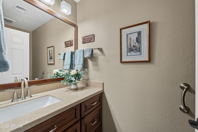 bathroom featuring vanity and visible vents