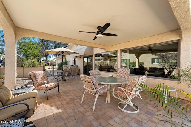 view of patio / terrace with outdoor dining space, a ceiling fan, and fence