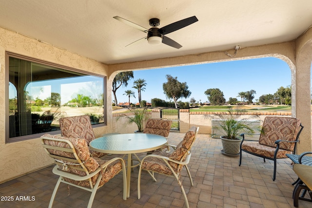 view of patio featuring outdoor dining area and ceiling fan