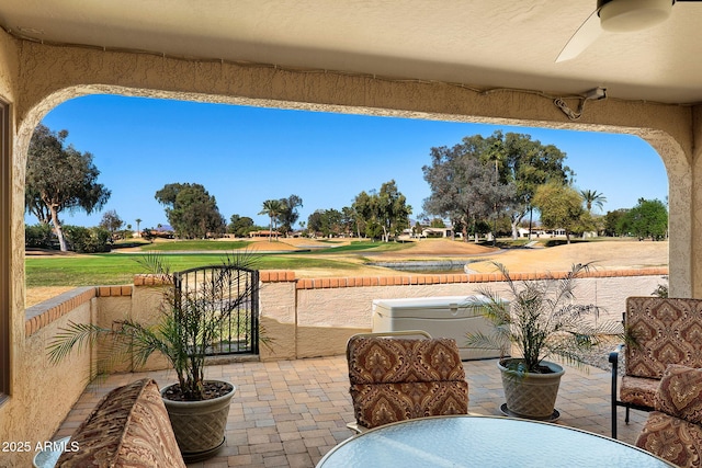 view of patio featuring fence and view of golf course