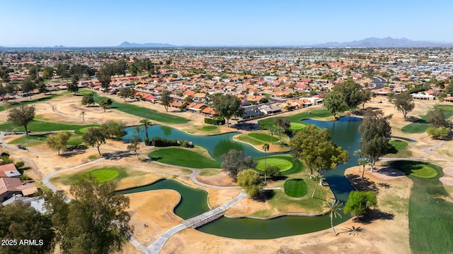 aerial view with a residential view, a water and mountain view, and view of golf course