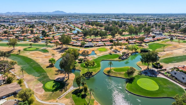 drone / aerial view with golf course view, a residential view, and a water and mountain view