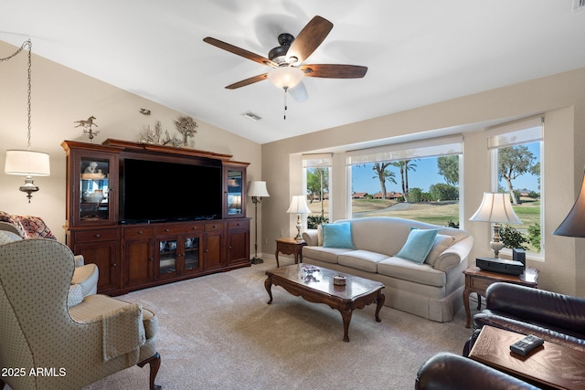 living room featuring a ceiling fan, baseboards, visible vents, vaulted ceiling, and light carpet