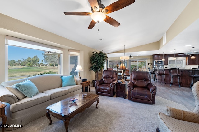 living room with visible vents, a ceiling fan, and vaulted ceiling