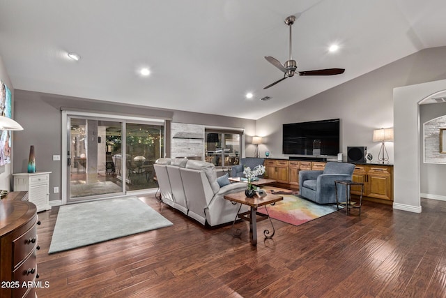 living room featuring wood finished floors, visible vents, baseboards, vaulted ceiling, and a ceiling fan