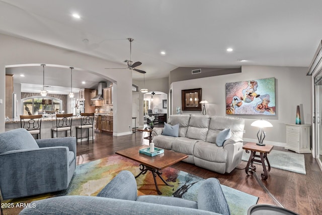 living room with dark wood-style flooring, lofted ceiling, recessed lighting, visible vents, and a ceiling fan