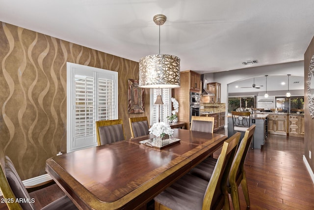 dining room featuring a wealth of natural light, dark wood-style flooring, visible vents, and baseboards