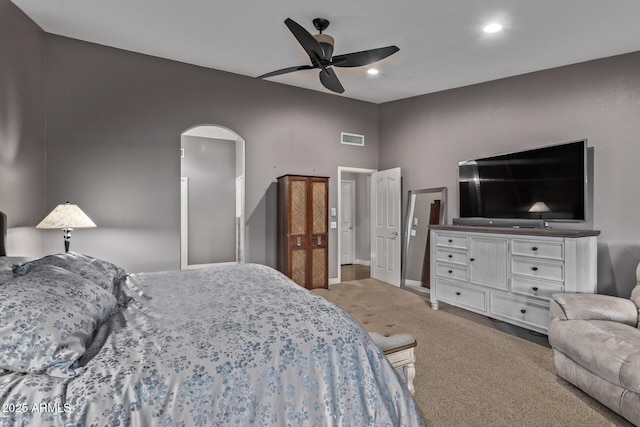 bedroom featuring arched walkways, recessed lighting, visible vents, baseboards, and carpet