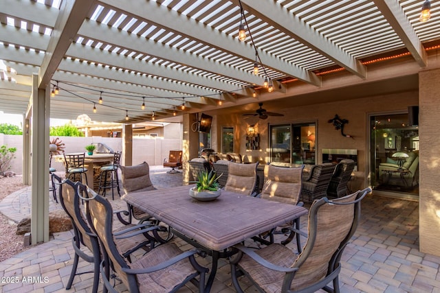 view of patio featuring outdoor dining space and fence