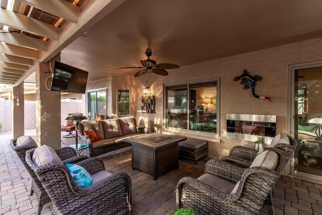 view of patio / terrace with fence, an outdoor living space, and a ceiling fan