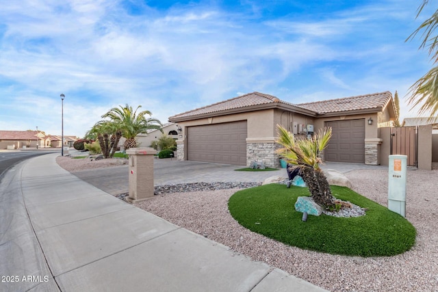 view of front of home featuring a tile roof, stucco siding, a garage, stone siding, and driveway