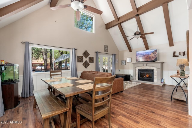 3971 N Apache Trl, Pine, AZ 85544 - dining space with ceiling fan, high vaulted ceiling, beamed ceiling, a warm lit fireplace, and wood finished floors