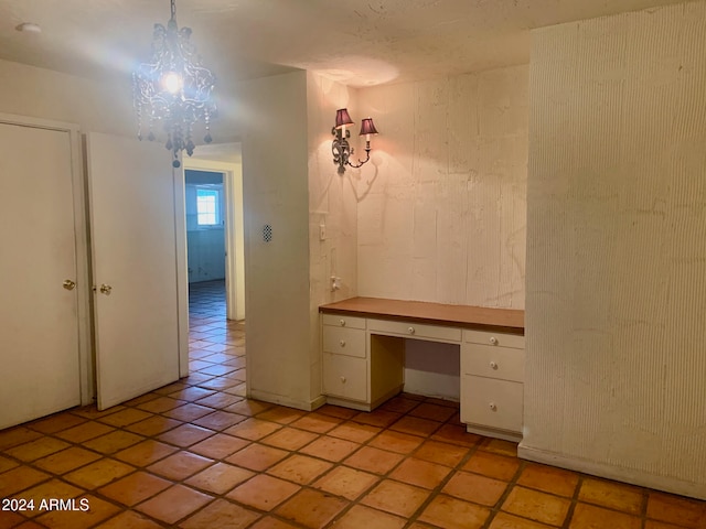 unfurnished office featuring an inviting chandelier