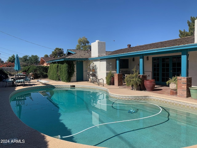 view of pool featuring a patio and a diving board