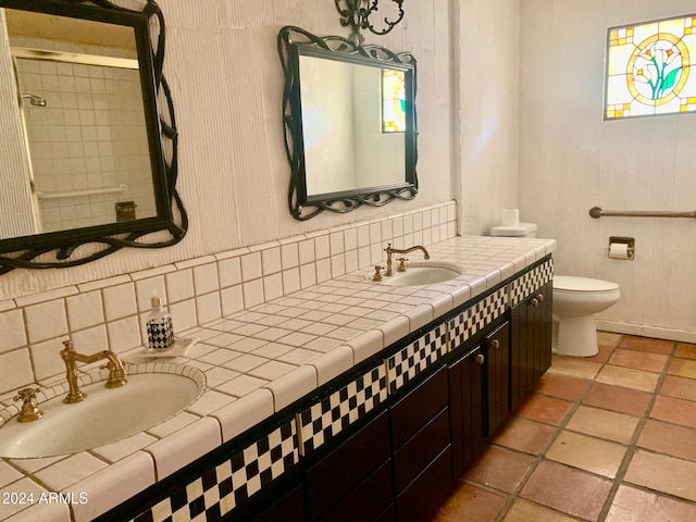 bathroom with vanity, tile patterned flooring, decorative backsplash, and toilet