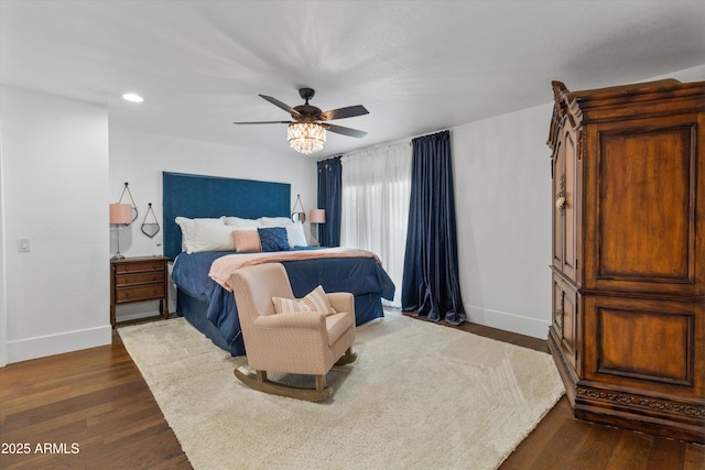 bedroom with ceiling fan and dark hardwood / wood-style floors