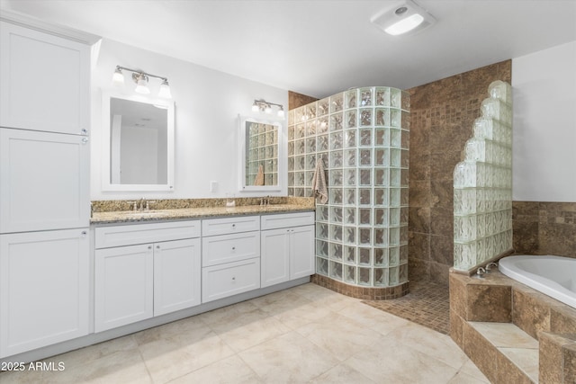 bathroom with vanity and separate shower and tub