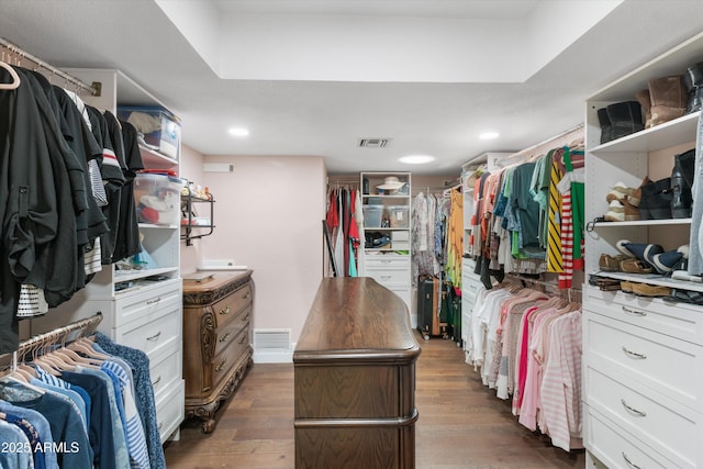 walk in closet with dark hardwood / wood-style flooring