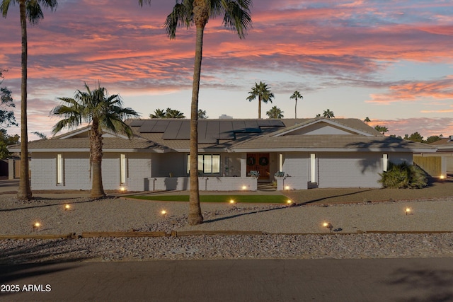 view of front of home with a garage and solar panels