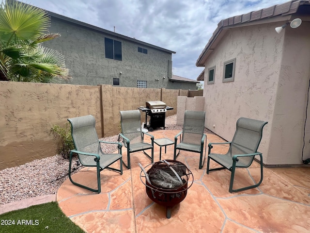 view of patio featuring a fire pit and a grill