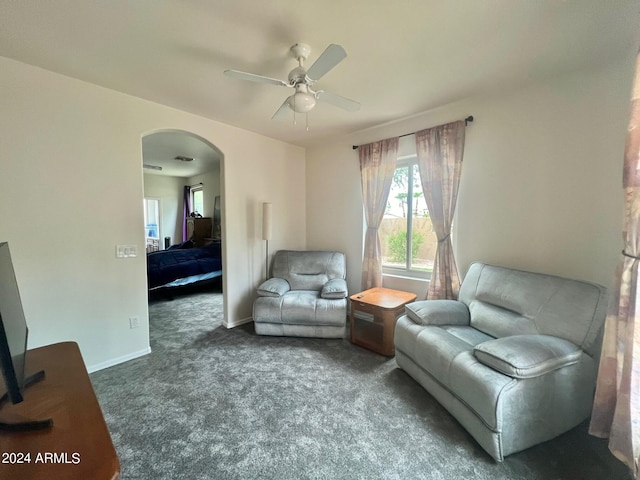 living room featuring carpet flooring and ceiling fan