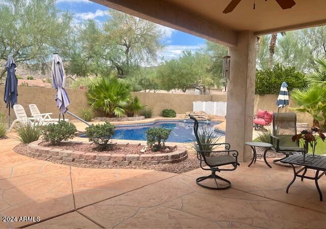 view of pool featuring a patio area and ceiling fan