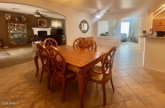 dining area featuring ceiling fan and light tile patterned floors