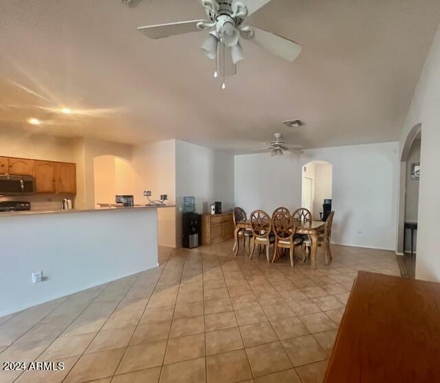 interior space featuring ceiling fan and light tile patterned floors