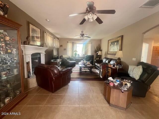 living room with ceiling fan and tile patterned floors