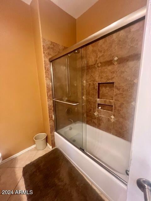 bathroom featuring shower / bath combination with glass door and tile patterned floors