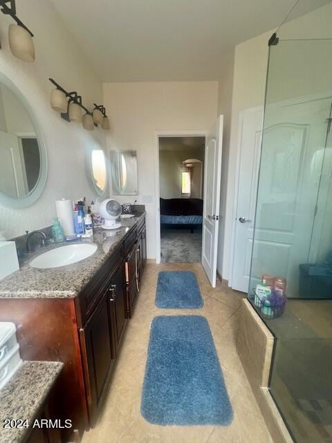 bathroom featuring vanity, an enclosed shower, and tile patterned floors