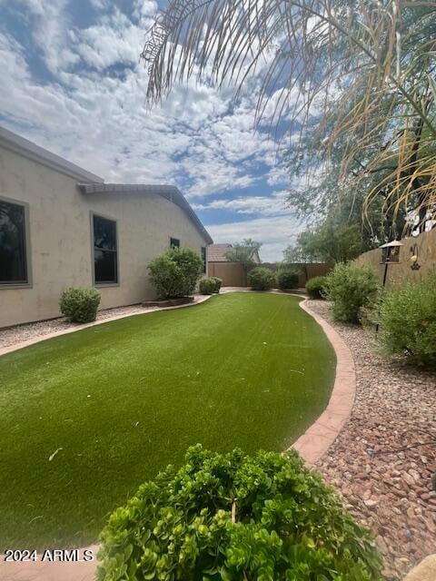 view of property's community with a lawn