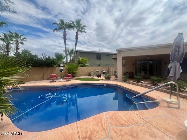 view of swimming pool with a patio