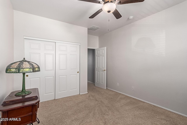 carpeted bedroom featuring ceiling fan and a closet