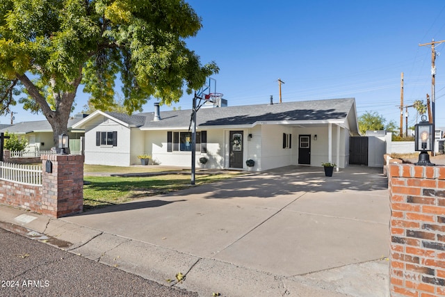 ranch-style home with a carport and a front yard