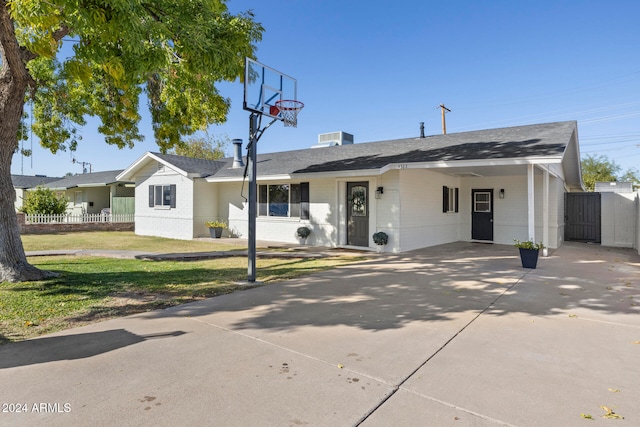 ranch-style house featuring a front yard and a carport