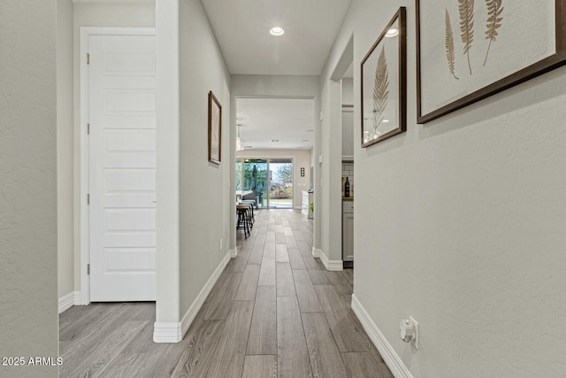 hallway with light hardwood / wood-style flooring