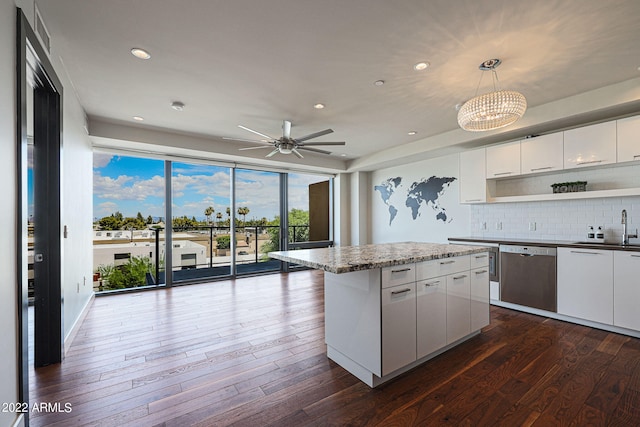 kitchen featuring a kitchen island, decorative light fixtures, white cabinetry, dishwasher, and dark hardwood / wood-style flooring