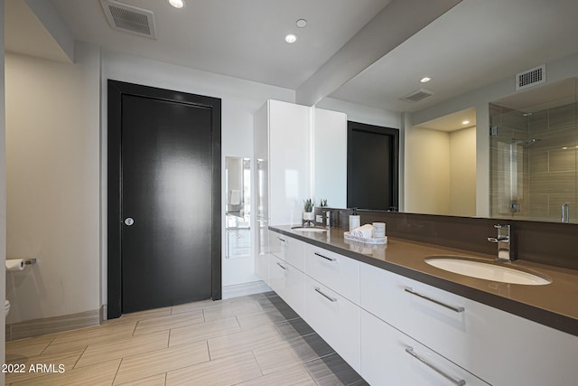 bathroom featuring walk in shower, vanity, and toilet