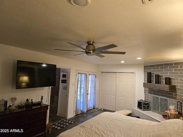 bedroom featuring a closet, recessed lighting, a textured ceiling, and ceiling fan