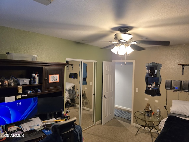 bedroom with ceiling fan, light carpet, a textured wall, a closet, and a textured ceiling