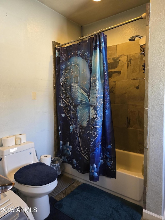 bathroom featuring toilet and shower / bath combo