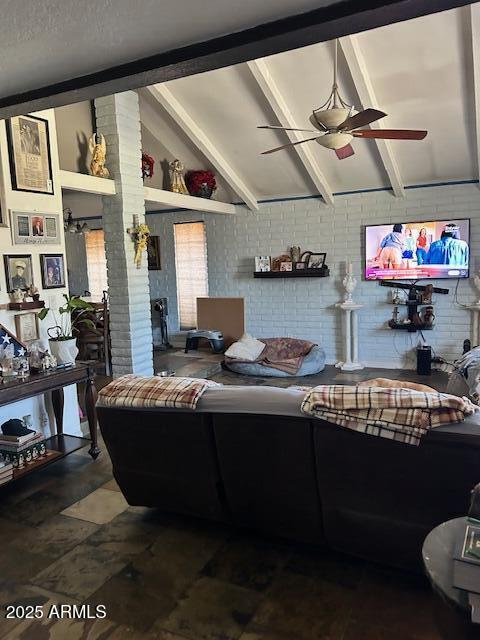 living room with vaulted ceiling with beams and ceiling fan
