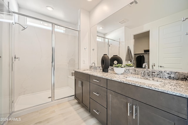 bathroom featuring vanity and a shower with shower door