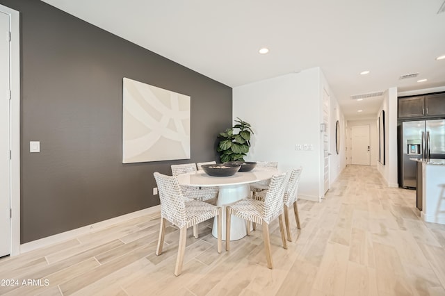 dining space with light hardwood / wood-style flooring