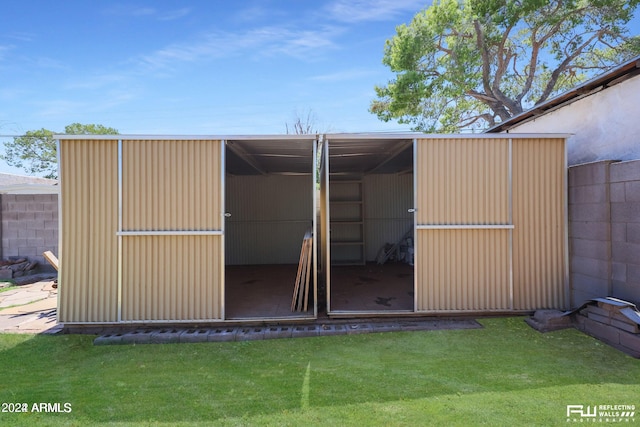 view of outdoor structure featuring a lawn