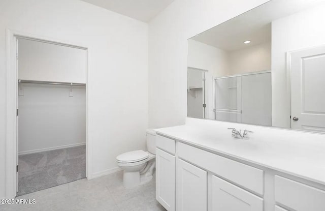 bathroom featuring vanity, toilet, and walk in shower