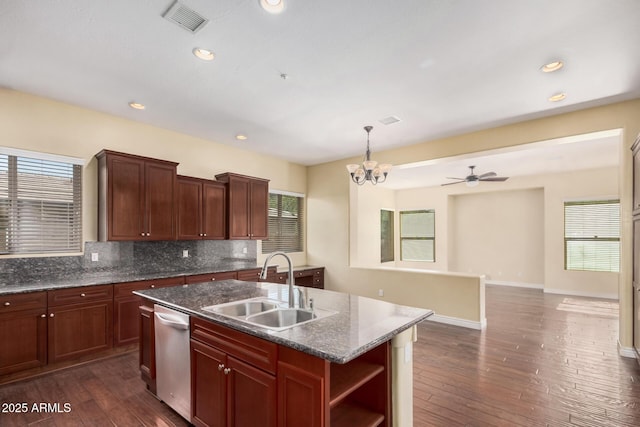 26796 N 86th Ln, Peoria, AZ 85383 - kitchen featuring dishwasher, dark wood-type flooring, an island with sink, a sink, and backsplash