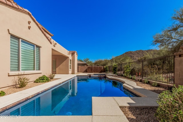 26796 N 86th Ln, Peoria, AZ 85383 - view of pool with a mountain view, a fenced backyard, a pool with connected hot tub, and a patio area